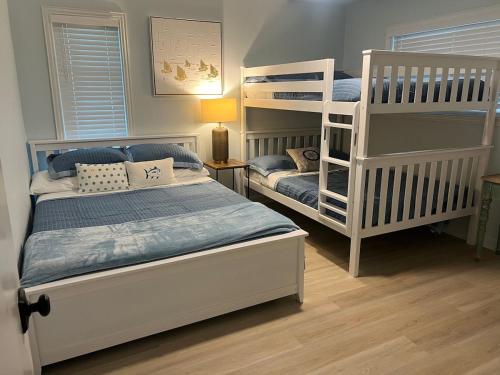 a bedroom with two bunk beds and a ladder at Harbor Point Hideaway,Sleeps 8, on open water in Gun Barrel City