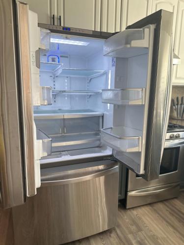 an empty refrigerator with its door open in a kitchen at Hayward Home in Hayward