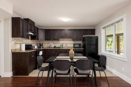 a kitchen with a table and chairs in a room at Peaceful Spacious 2br Suite in Nanaimo