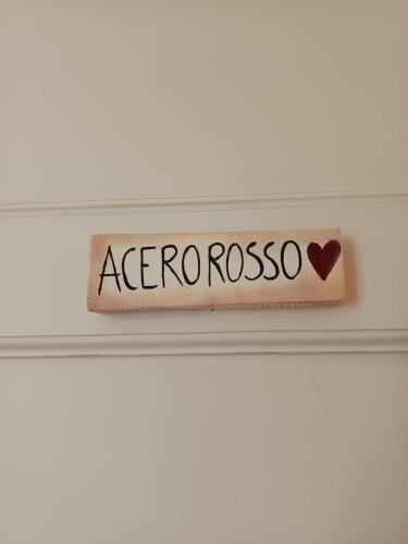 a sign that says acongorosos on a shelf at L'Acero Rosso in Lucca