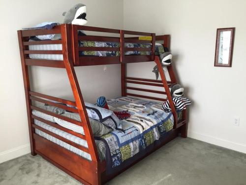 a bunk bed in a room with a bed at Roof-Top Deck With Ocean & Bay Views Single Family Beach Badges Private Yard Ping Pong And Pool Table Wifi 1 Block From Ocean 15 Blocks To Bay in Ship Bottom