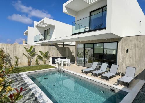 an image of a house with a swimming pool at Elysian Blue villa 2 in Paphos