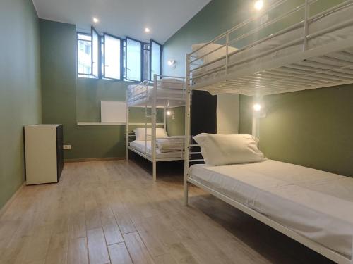 a room with two bunk beds and a window at Cinhouse in Milan