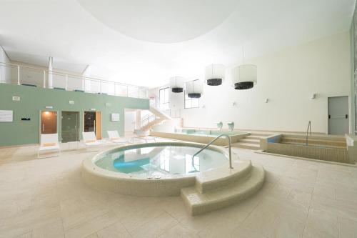 a large room with a hot tub in a building at St Martin Beach Resort & Spa in Anse Marcel 