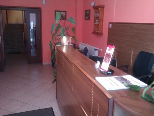 a court room with a reception desk and avertisement at Penzion Premona in Nitra