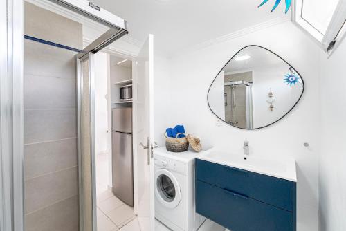 a bathroom with a washing machine and a mirror at Lolas in Puerto del Carmen