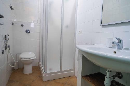 a bathroom with a sink and a shower and a toilet at ISLAVENTO case vacanza Trapani in Trapani