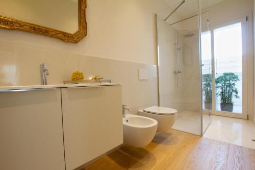 a white bathroom with a toilet and a shower at Dimora 26 - B&B - in Spresiano