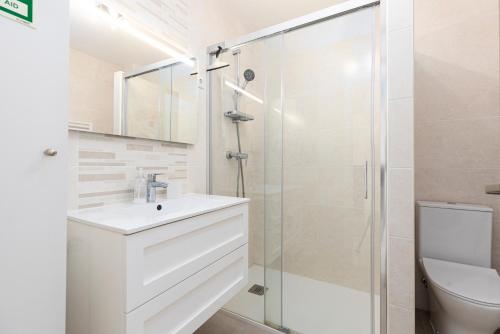 a bathroom with a white sink and a shower at Apartment Estrelícia Direct beach access in Porches