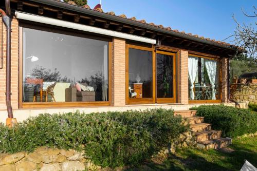 a house with a large window on the side of it at Cottage La Dolce Agogia Panicale in Panicale