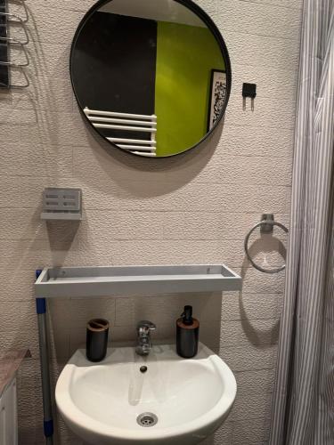 a bathroom with a sink and a mirror at OldTown Apartments Ferhadija in Sarajevo