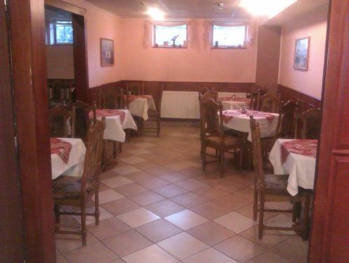 a dining room with tables and chairs in a restaurant at Penzion Premona in Nitra
