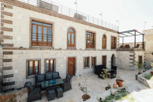 a large brick house with a patio in front of it at Gala Cave Cappadocia in Goreme