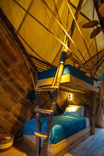 a bunk bed in a room with a ceiling at QASA Hotel and Retreat Center in San Luis