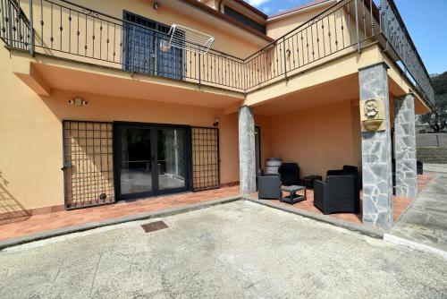 a house with a balcony and a patio at AIR B&B PLEASANT MOMENTS in Bolsena