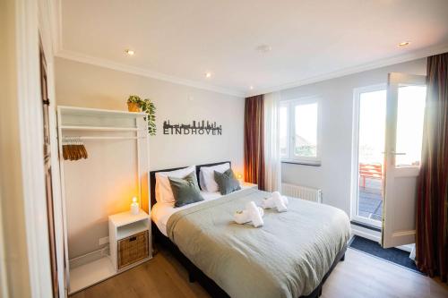 a bedroom with a bed with two stuffed animals on it at Supreme 75m2 Two-Bedroom Apartment - VW142 in Eindhoven