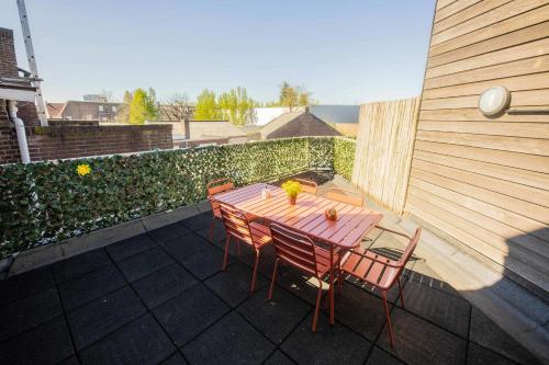 a wooden table and chairs on a patio at Supreme 75m2 Two-Bedroom Apartment - VW142 in Eindhoven