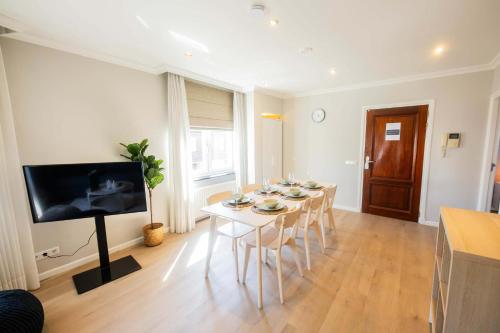 a dining room with a white table and chairs at Supreme 75m2 Two-Bedroom Apartment - VW142 in Eindhoven