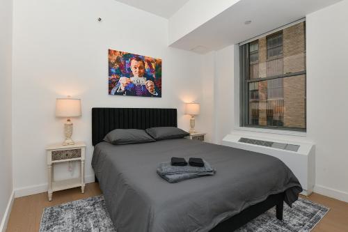 a bedroom with a bed and a picture on the wall at The Wolf of Wall Street Apartment in New York