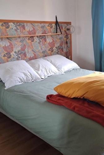 - un lit avec 2 oreillers et une couverture dans l'établissement Charmant cosy T3, à Ajaccio