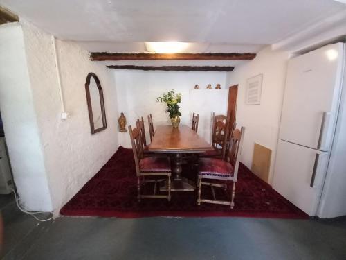 a dining room with a table and chairs and a refrigerator at Casa Coerente Cavergno - Room 1 in Cevio