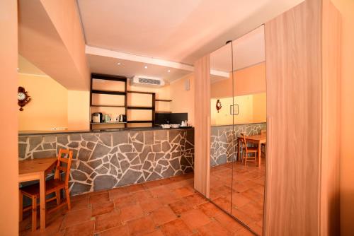 a kitchen and dining room with a table and chairs at AIR B&B PLEASANT MOMENTS in Bolsena