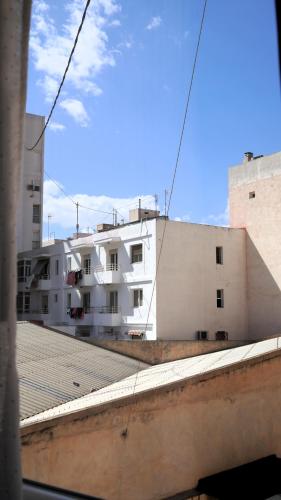 a view of a white building from a window at El Patio Hostal in Alicante