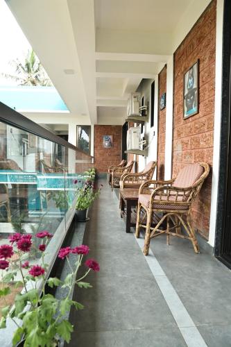 a row of chairs and tables on a building with flowers at Fusion Home in Anjuna