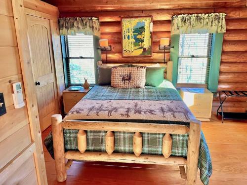 a bedroom with a bed in a log cabin at Smoky Mountains Blue Ridge Cabin Tennessee in Maryville