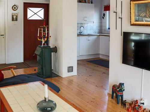 a living room with a table and a kitchen at 4 star holiday home in SKÅNE VEJBYSTRAND in Vejbystrand