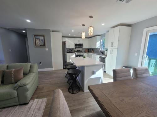 a kitchen and living room with a couch and a table at Jungle in the City! in West Palm Beach
