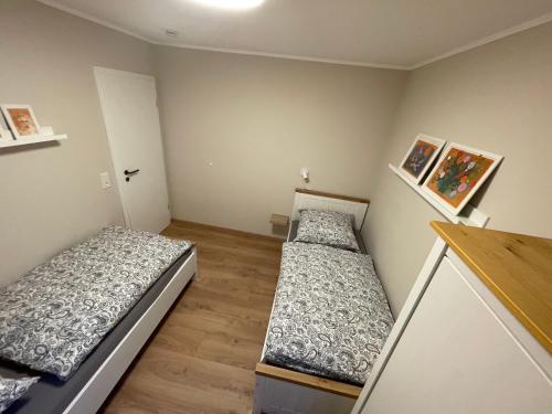 a room with two beds in it with at Stylisches Landhaus Eifelgruß mit Top Lage, direkt am Wald und einzigartigem Naturgarten in Oberbettingen