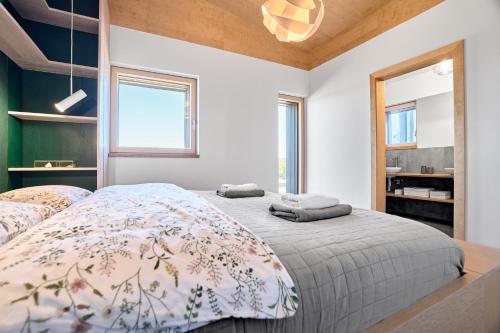 a bedroom with a large bed with a blanket at Chalet Popcorn by Mountain ways in Abertamy