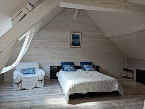 une chambre avec un lit et une chaise dans l'établissement Duplex dans belle propriété avec piscine, à Les Essarts-le-Roi
