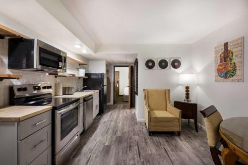a kitchen with stainless steel appliances and a dining room at Revel Hotel Minot - SureStay Collection by Best Western in Minot