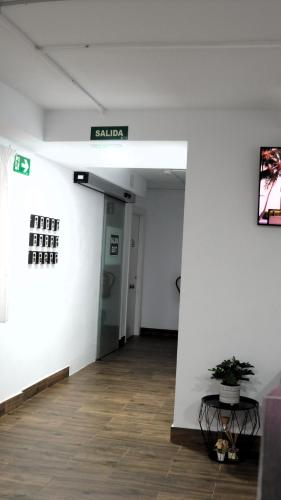 a hallway in a building with a sign on the wall at El Patio Hostal in Alicante