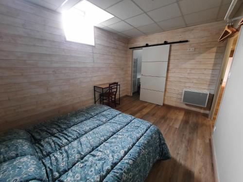 a bedroom with a bed and a television in it at Gîte de charme à la campagne in Ampoigné