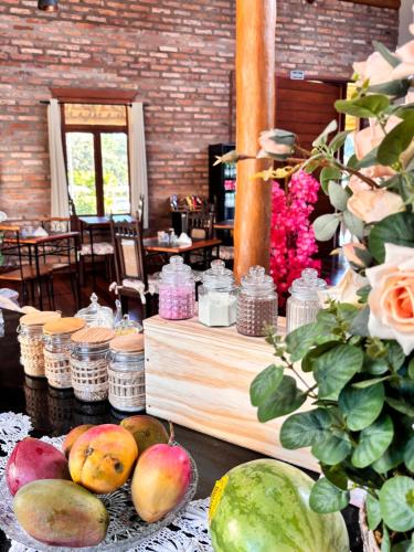 a table with apples and other fruits on a table at Recanto da Natureza in Brotas