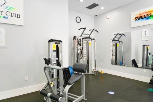 a gym with cardio equipment in a room at Modern Luxury Condo Near Beach & Aventura Mall in Aventura