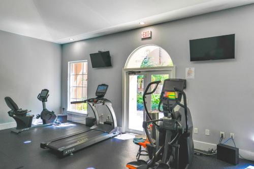 a gym with treadmills and ellipticals in a room at Modern Luxury Condo Near Beach & Aventura Mall in Aventura