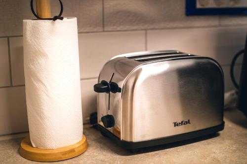 a toaster and a roll of paper towels on a counter at Holiday house David in Podčetrtek