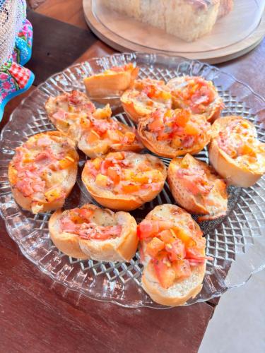 a glass plate with shrimp sandwiches on a table at Recanto da Natureza in Brotas
