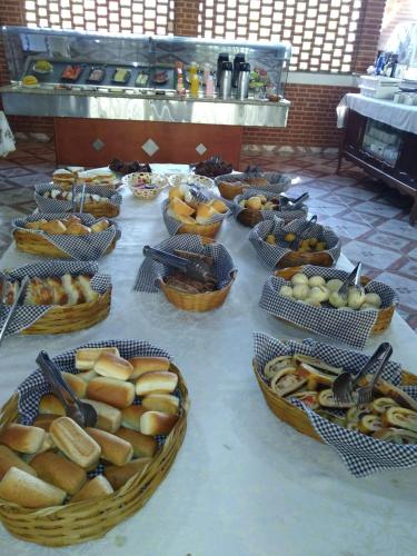 una mesa con cestas de pan y cestas de comida en Pousada Campestre Estância São Domingos, en Serra Negra