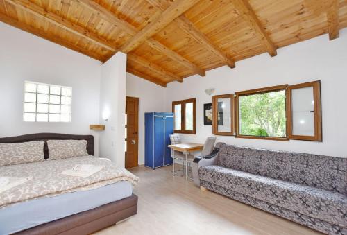 a bedroom with a bed and a couch at Apartments Pegaz in Virpazar