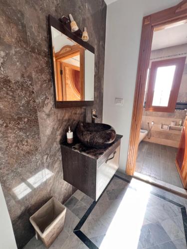 a bathroom with a sink and a mirror at Private floor of a villa - 10 min to airport in Ariana