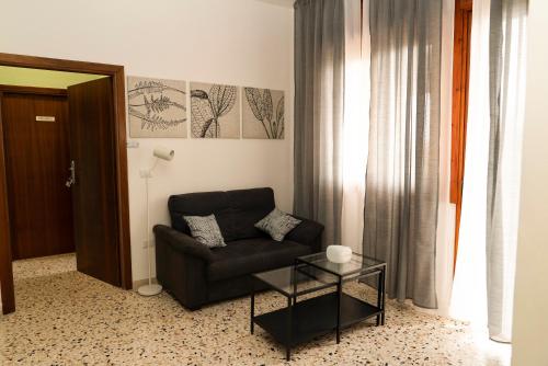 a living room with a couch and a glass table at Casa Carrella in Salerno