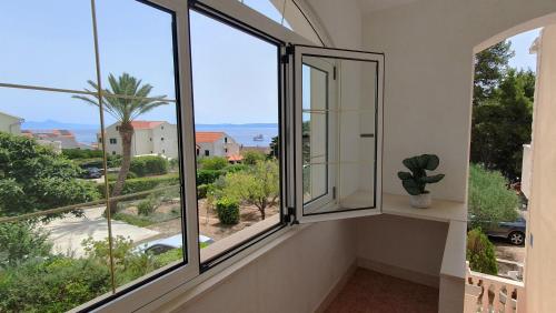a balcony with windows and a view of a street at Apartmani Marijana in Bol