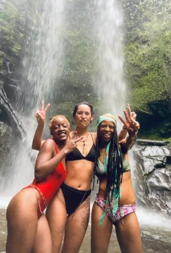 three women standing in front of a waterfall at Casa Teka a Peaceful Stay Near Beach and Town in Cocles