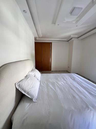 a bedroom with a bed with a pillow on it at Private floor of a villa - 10 min to airport in Ariana