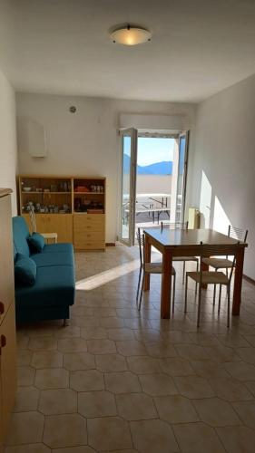 a living room with a table and a blue couch at the house on the Orfento in Caramanico Terme